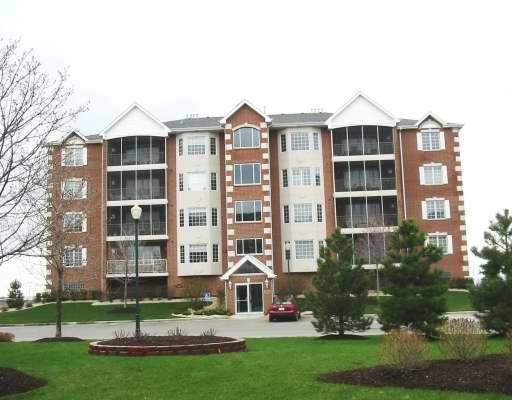 Front view of a multi-story apartment building with brick exterior.