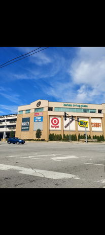 Front view of a commercial building with multiple store signs including Target, Best Buy, and Hobby Lobby.