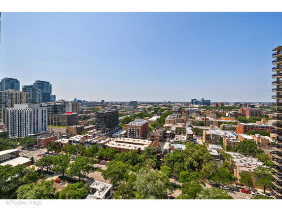 Panoramic view of cityscape with multiple buildings and clear sky.