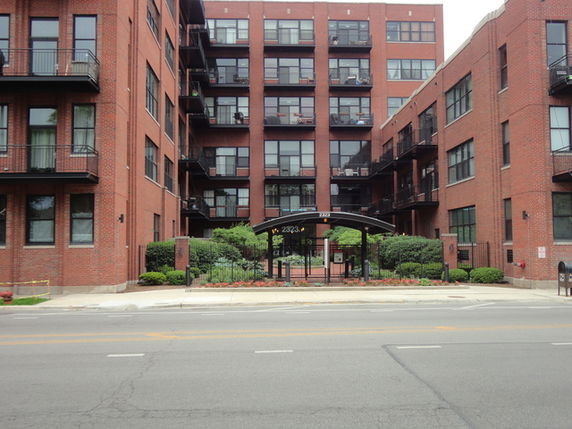 Front view of a multi-story brick apartment building.