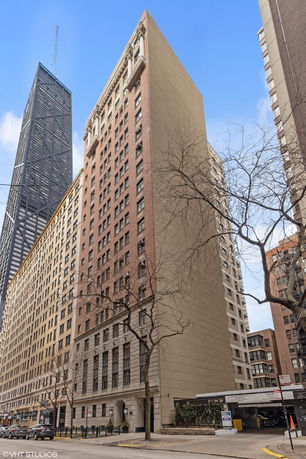 Front view of a tall urban building with multiple stories.
