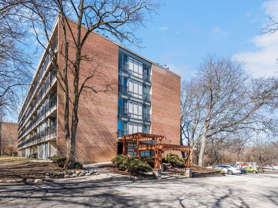 Front view of a multi-story brick building with balconies.