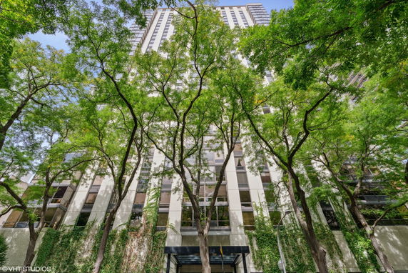 Front view of a high-rise building with trees in the foreground.