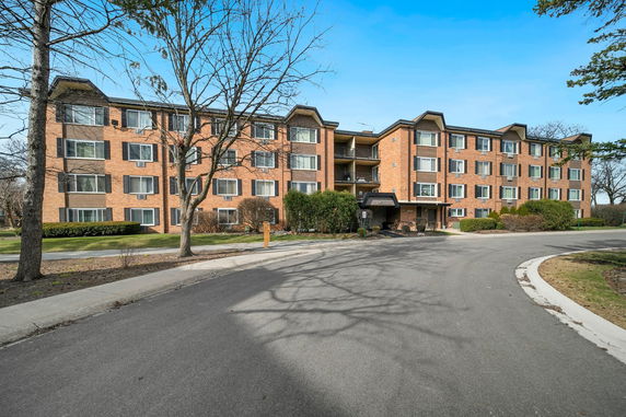 Front view of a four-story brick apartment building.