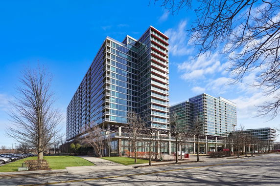 Front view of a modern multi-story glass office building.