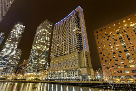 Night view of high-rise buildings with prominent lighting on the facades.