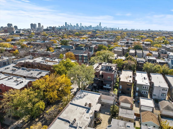 Panoramic view of urban residential area with city skyline in the background.