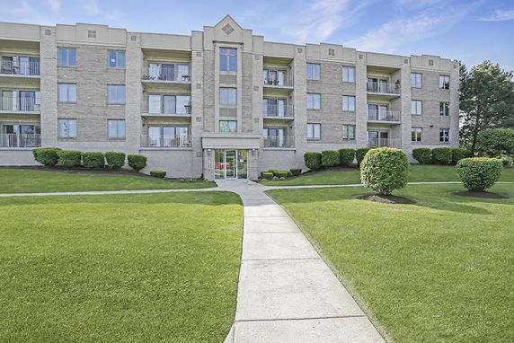 Front view of a multi-story residential building with balconies.