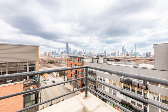 Panoramic view of a city from a building balcony.