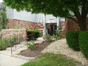 Entrance view of a building with brick walls and a ramp.