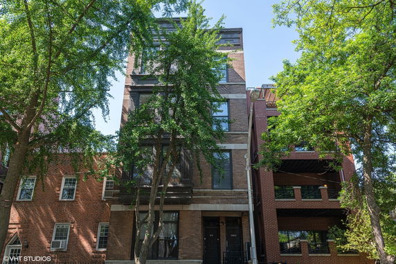 Front view of a multi-story brick building.
