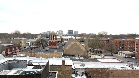 Panoramic view of urban buildings and a distant skyline.