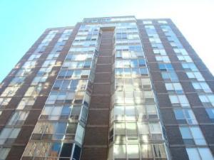 Front view of a multi-story glass and brick building.