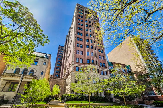 Front view of a tall multi-story building with a brick facade.