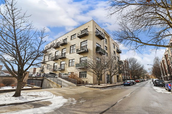Front view of a multi-story building with balconies.