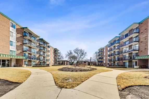 Front view of multiple multi-story apartment buildings with balconies.