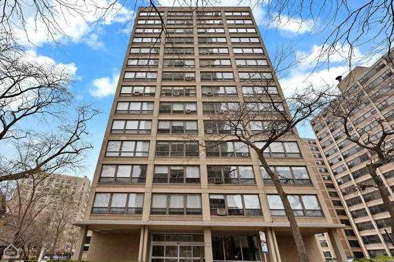 Front view of a high-rise apartment building with multiple windows.