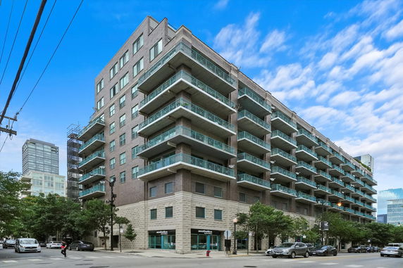 Front view of a multi-story residential building with balconies.