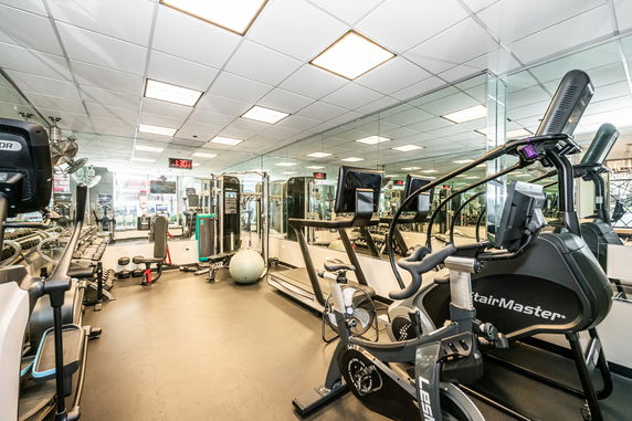 Indoor gym area with various fitness equipment.
