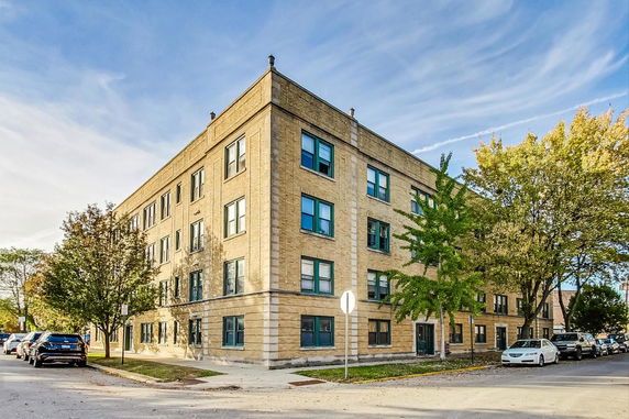 Front view of a multi-story brick apartment building.