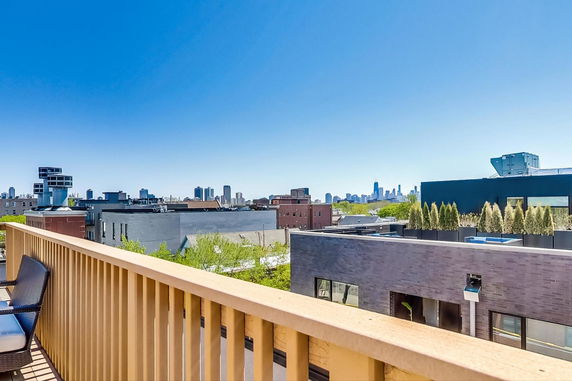 Wide angle view of city skyline from a rooftop.