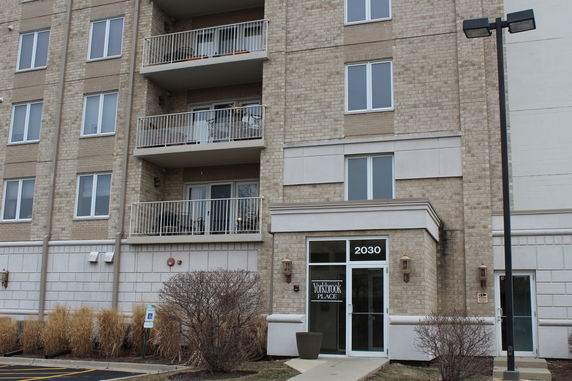 Front view of a multi-story residential building with balconies.
