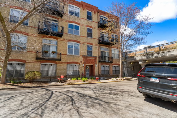 Front view of a multi-story residential building with balconies.