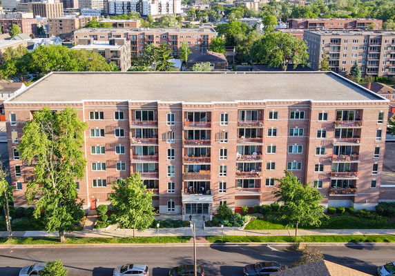 Front view of a multi-story brick building with balconies.
