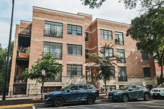 Front view of a multi-story brick apartment building.