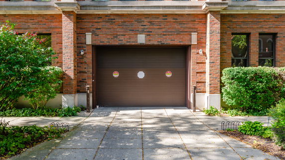 Front view of a brick building with a garage door.