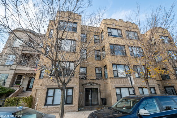 Front view of a multi-story brick apartment building.