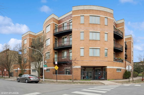Front view of a multi-story brick building with balconies.