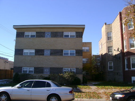 Front view of a three-story apartment building with a simple facade.