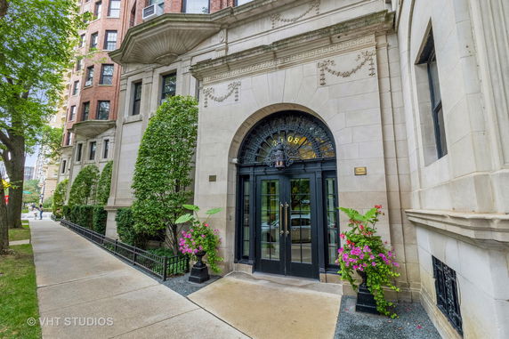 Front view of a building with an ornate entrance and arched doorway.