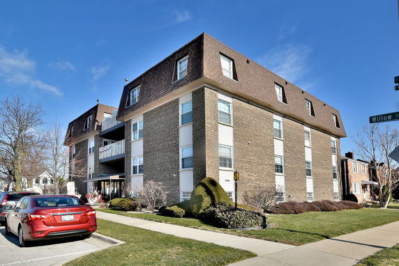 Front view of a multi-story residential building with a brick exterior.
