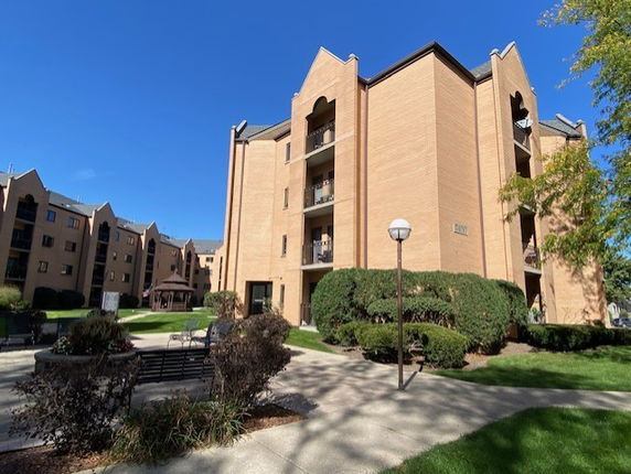 Front view of a multi-story apartment building with balconies.