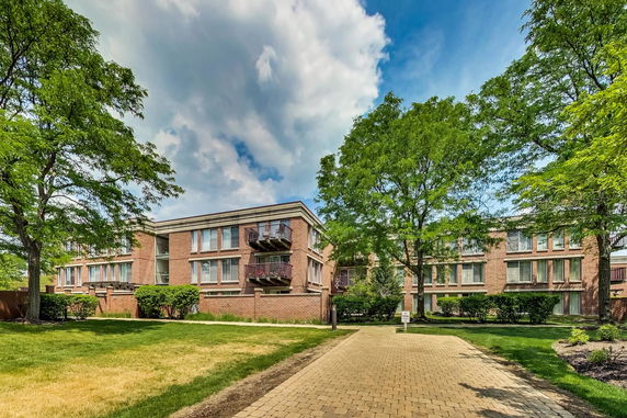 Front view of a two-story brick building with balconies.