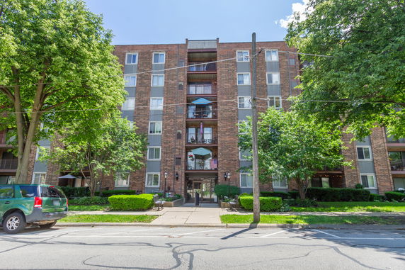 Front view of a multi-story residential building with balconies.