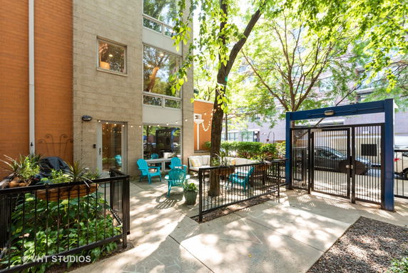Front view of a building with a patio area and outdoor seating.