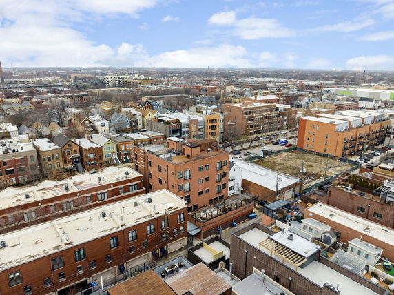 Aerial panoramic view of a cityscape with various residential buildings.
