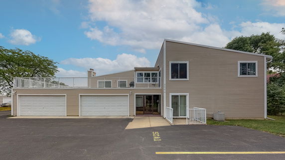 Front view of a two-story house with a triple garage.