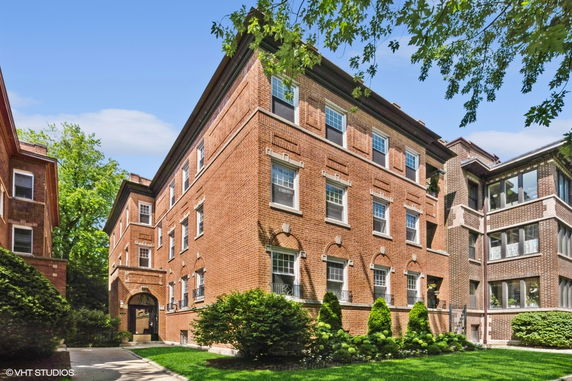 Front view of a multi-story brick apartment building.