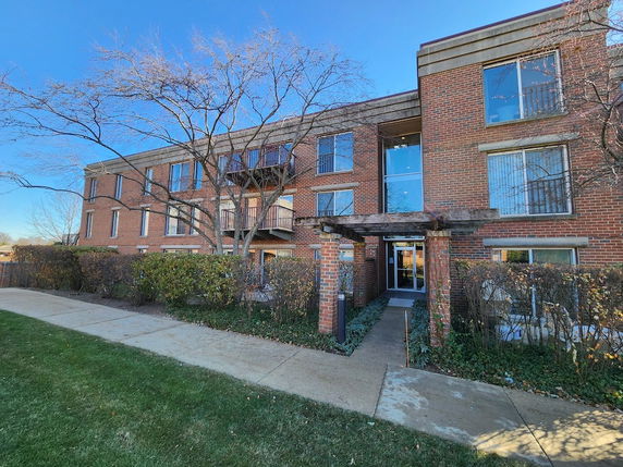Front view of a three-story brick apartment building.