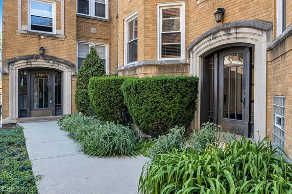 Front view of a brick apartment building entrance.