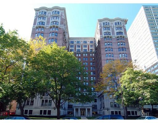 Front view of a multi-story residential building with a symmetrical design.