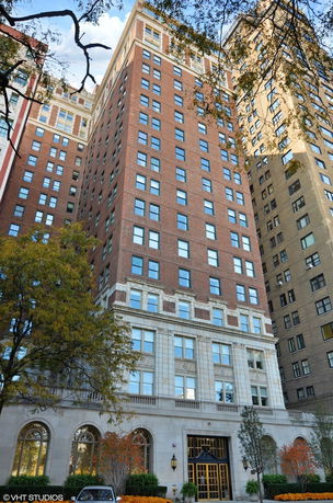 Front view of a multi-story brick building with many windows.