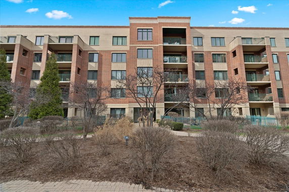 Front view of a multi-story residential building with balconies.