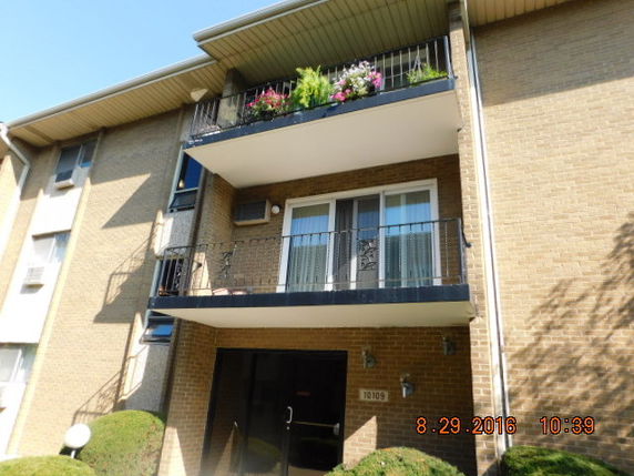 Front view of a multi-story building with balconies.