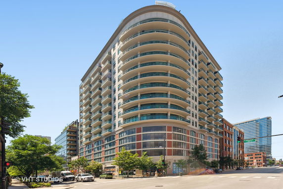 Front view of a multi-story residential building with curved balconies.