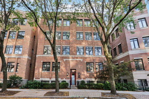 Front view of a multi-story brick apartment building.